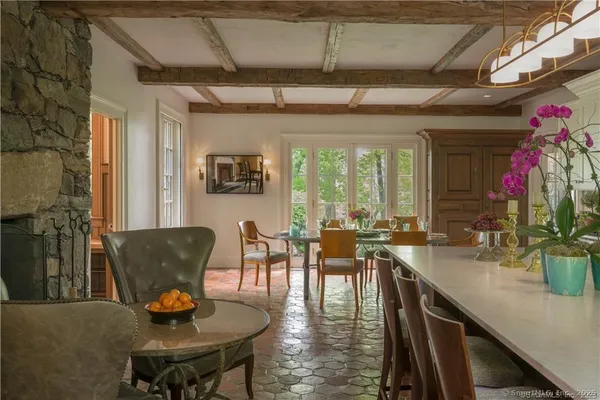 a dining room with furniture a chandelier and wooden floor