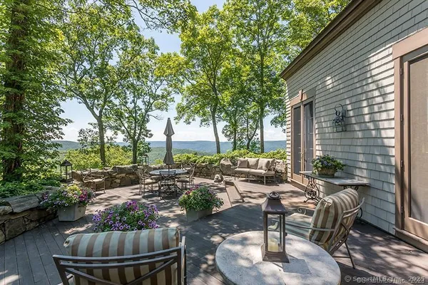 a living room with patio furniture and a potted plant