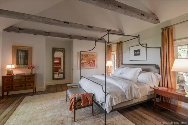 a bedroom with a large bed and a window