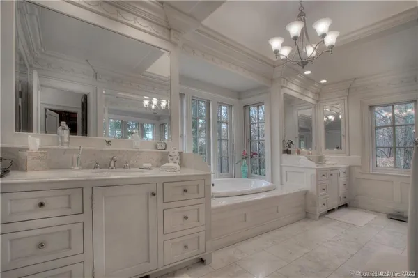 a bathroom with a granite countertop sink mirror and bathtub