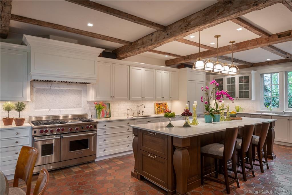 33 Nodine Pasture Road Kent, CT 06757 - Photo 6 of 40 a kitchen with a stove a sink and chairs