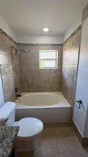 a bathroom with a toilet bathtub and shower