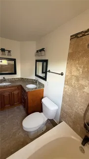 a bathroom with a toilet a sink and a bathtub