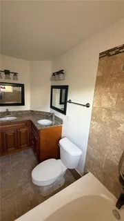 a bathroom with a toilet a sink and a bathtub