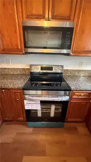 a stove top oven sitting inside of a kitchen