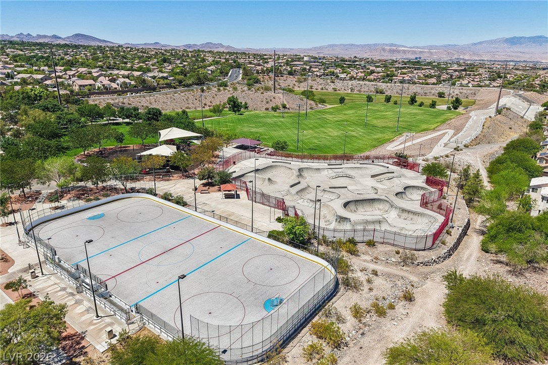 1176 Butternut Ranch Court Henderson, NV 89052 - Photo 60 of 60 An aerial perspective reveals a vibrant community park featuring a skatepark and an outdoor rink.