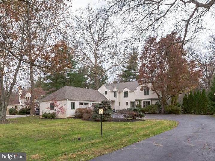 a white house that has a tree in front of it