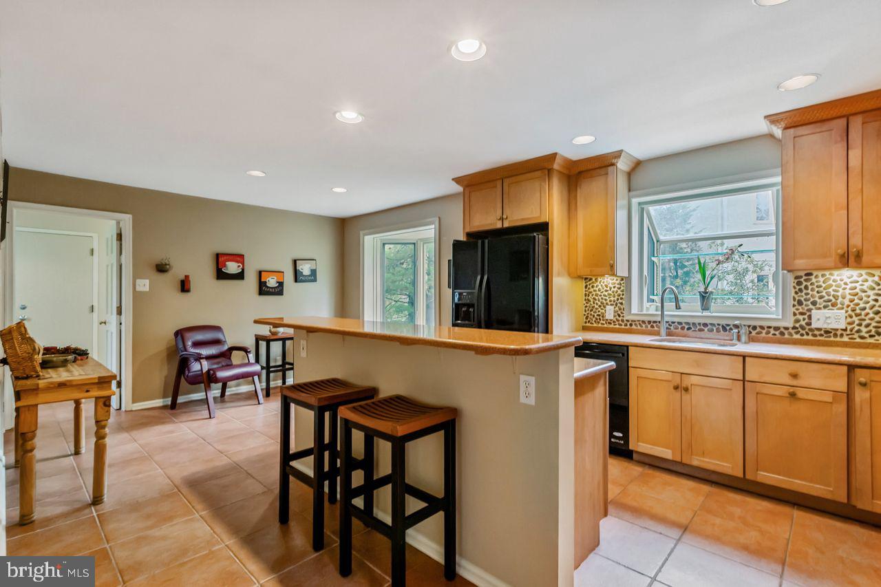 540 Harriton Road Bryn Mawr, PA 19010 - Photo 11 of 35 a open kitchen with stainless steel appliances granite countertop a table and chairs in it