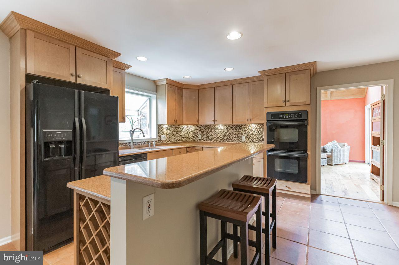 540 Harriton Road Bryn Mawr, PA 19010 - Photo 12 of 35 a kitchen with stainless steel appliances granite countertop a refrigerator a stove and a sink