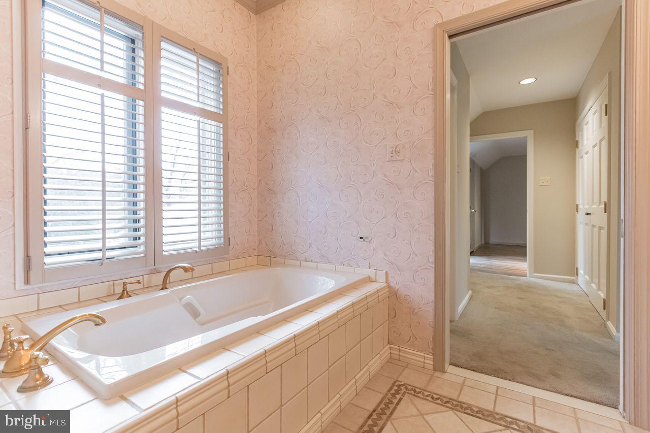540 Harriton Road Bryn Mawr, PA 19010 - Photo 23 of 35 a bath tub sitting in a bathroom next to a window