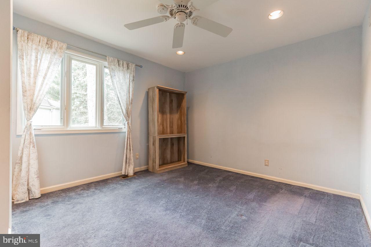 540 Harriton Road Bryn Mawr, PA 19010 - Photo 24 of 35 an empty room with chandelier fan and windows