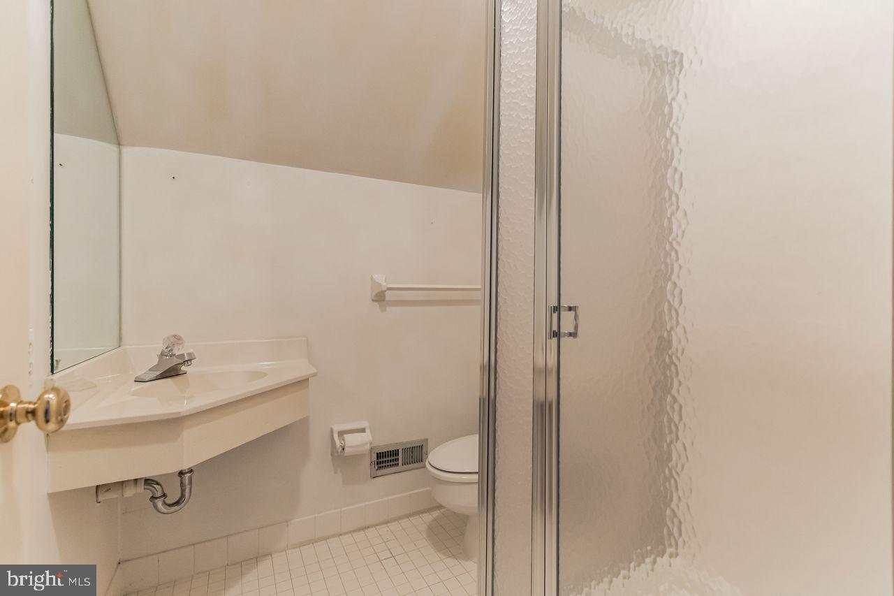 540 Harriton Road Bryn Mawr, PA 19010 - Photo 26 of 35 a bathroom with a sink a toilet and shower