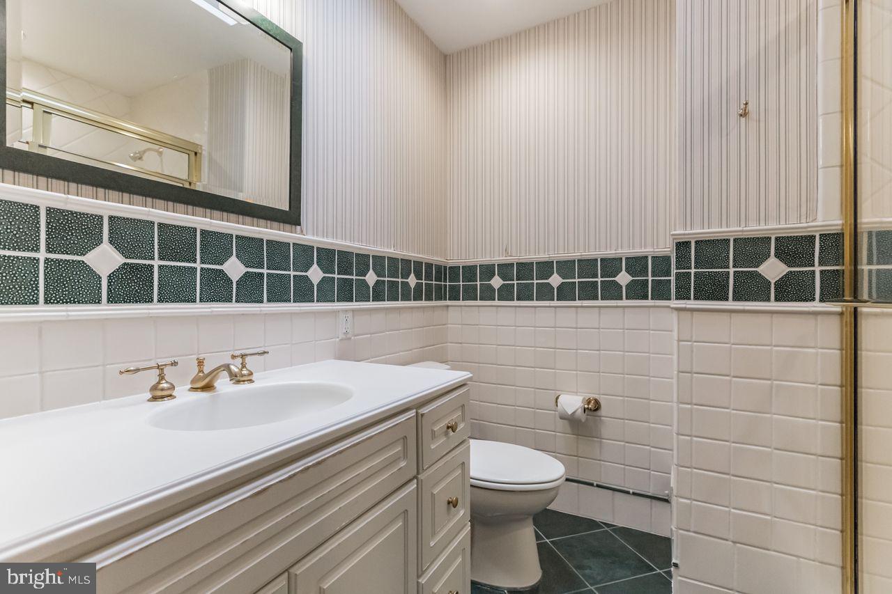 540 Harriton Road Bryn Mawr, PA 19010 - Photo 29 of 35 a bathroom with a sink a toilet and shower