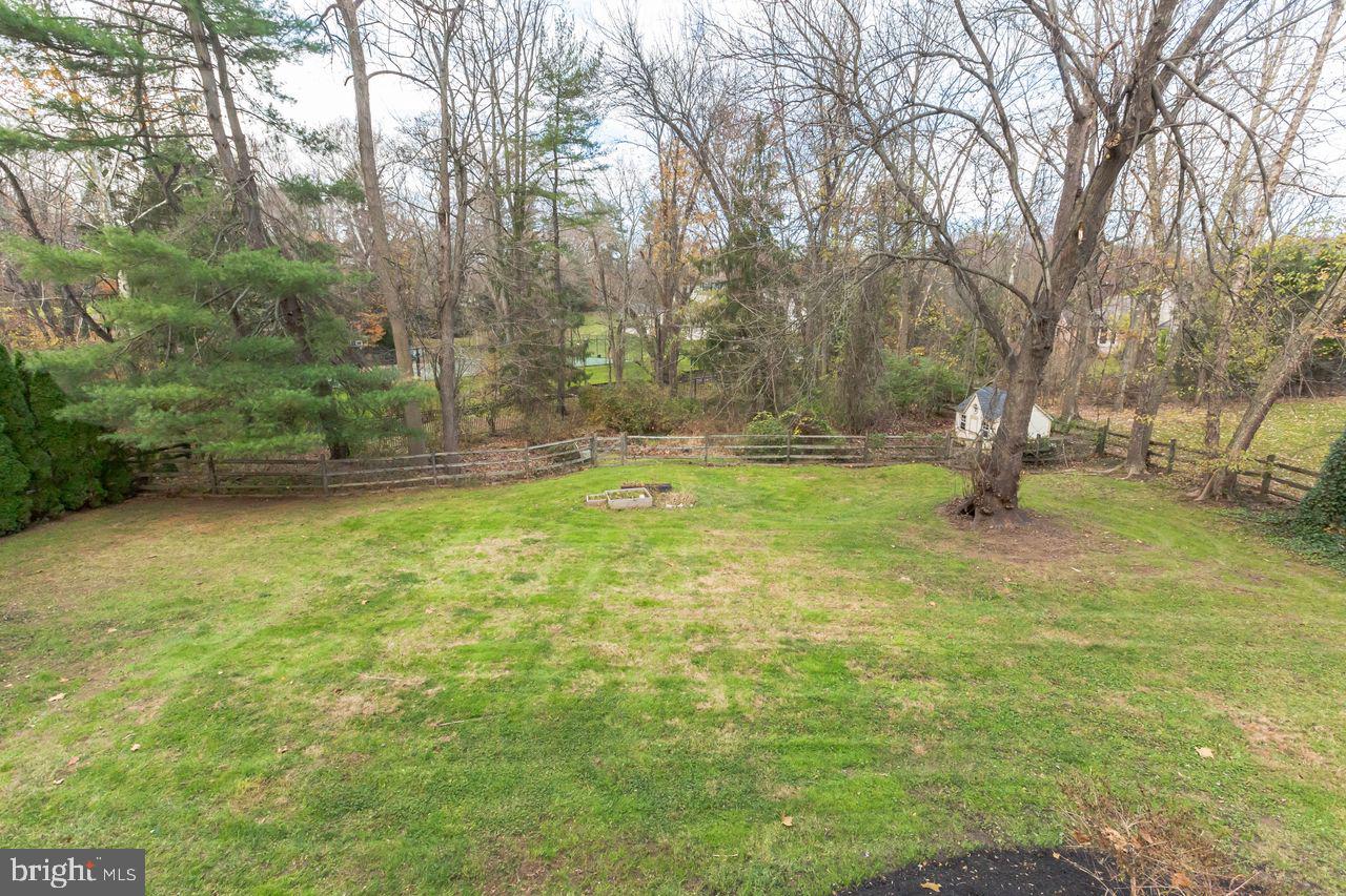 540 Harriton Road Bryn Mawr, PA 19010 - Photo 34 of 35 a backyard of a house with lots of green space and fountain