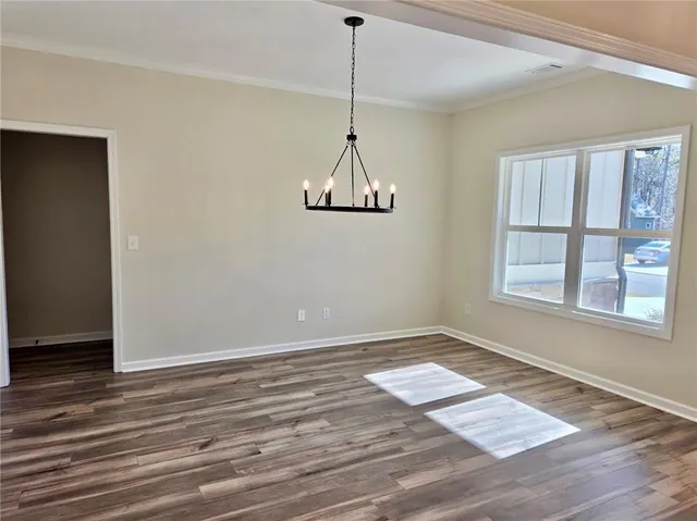 a view of a room with window wooden floor and glass door