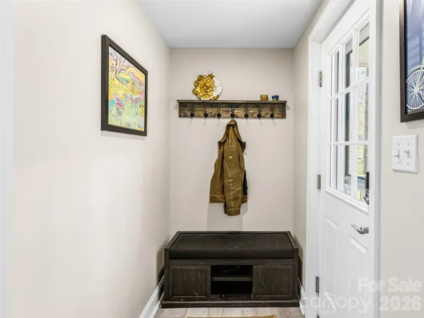 a view of entryway and hall with wooden floor