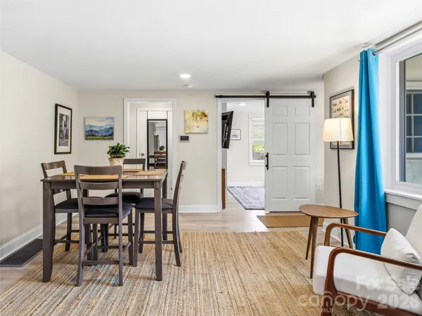 a view of a dining room with furniture and wooden floor