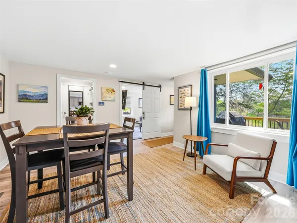 a view of a dining room with furniture window and wooden floor
