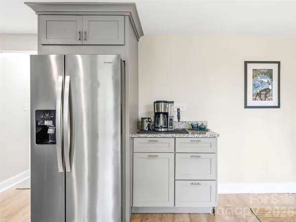 a kitchen with stainless steel appliances a refrigerator and cabinets