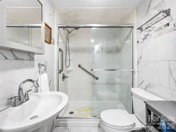 a bathroom with a sink toilet and shower