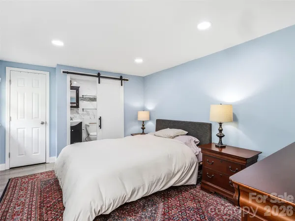 a bedroom with a bed and a lamp