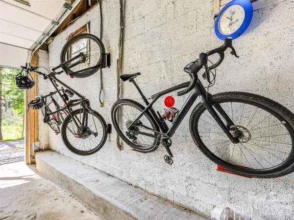 a view of a backyard with plants and wooden fence