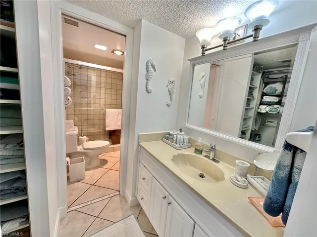 a spacious bathroom with a double vanity sink a mirror and a shower