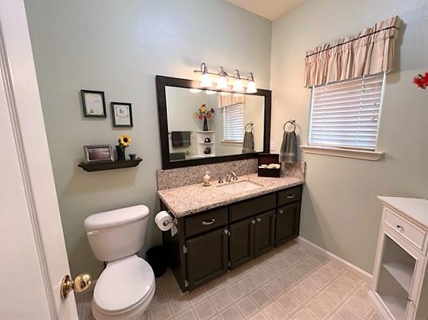 1278 Nelson Boulevard Selma, CA 93662 - Photo 10 of 14 a bathroom with a granite countertop toilet sink and mirror