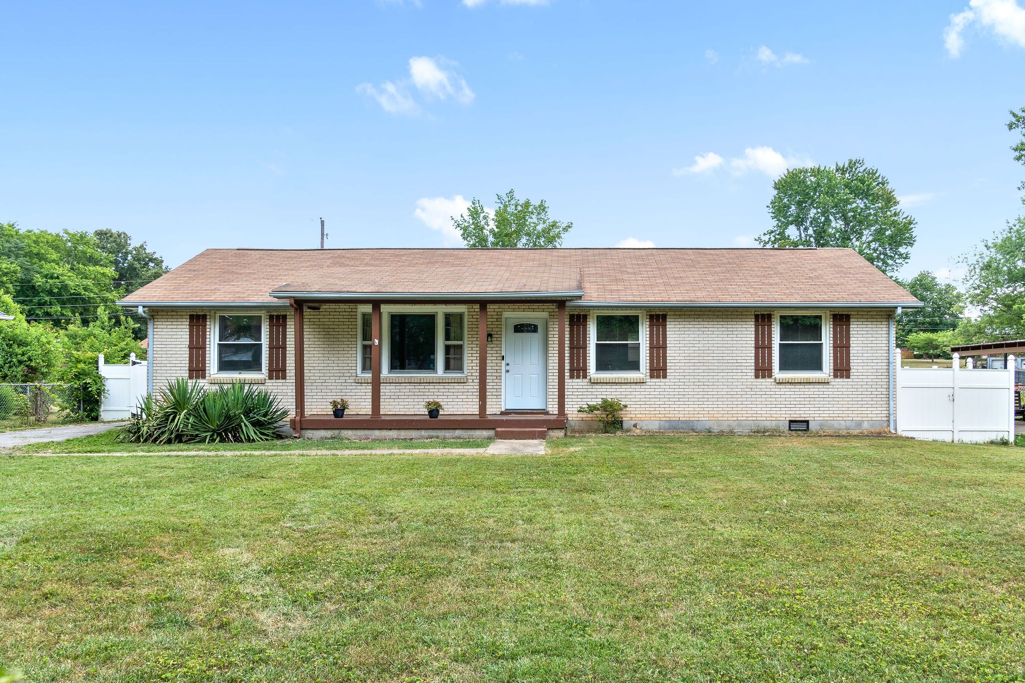 573 Lafayette Road Clarksville, TN 37042 - Photo 1 of 31 a front view of a house with a garden and porch