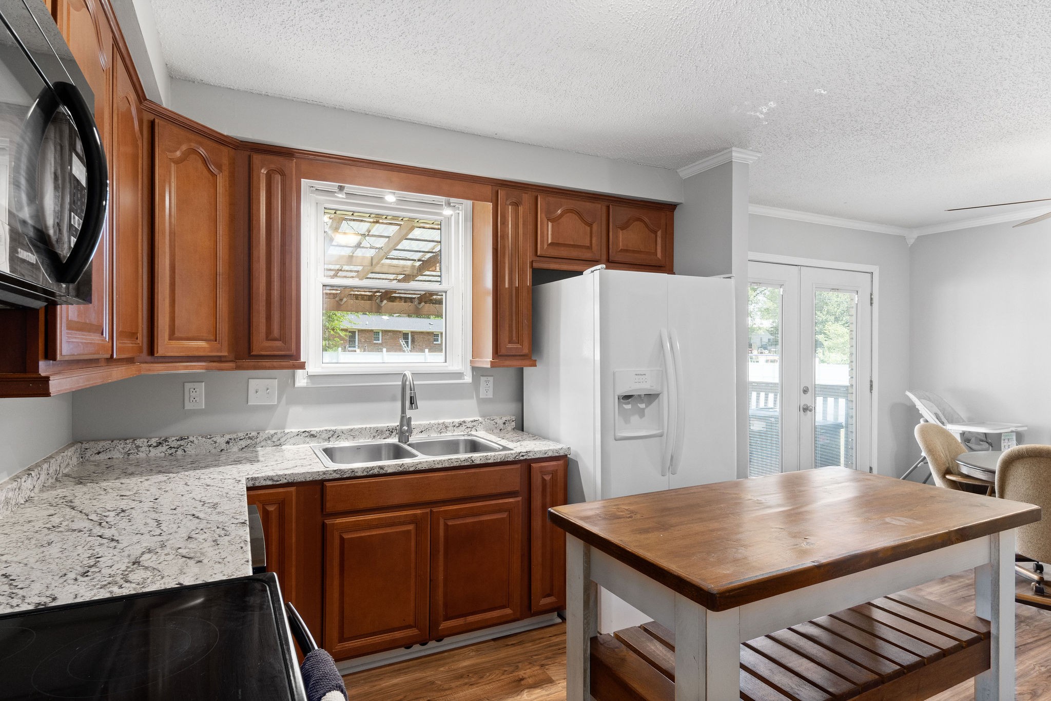 573 Lafayette Road Clarksville, TN 37042 - Photo 12 of 31 a kitchen with stainless steel appliances granite countertop a sink a stove a refrigerator a microwave oven with white cabinets and wooden floor