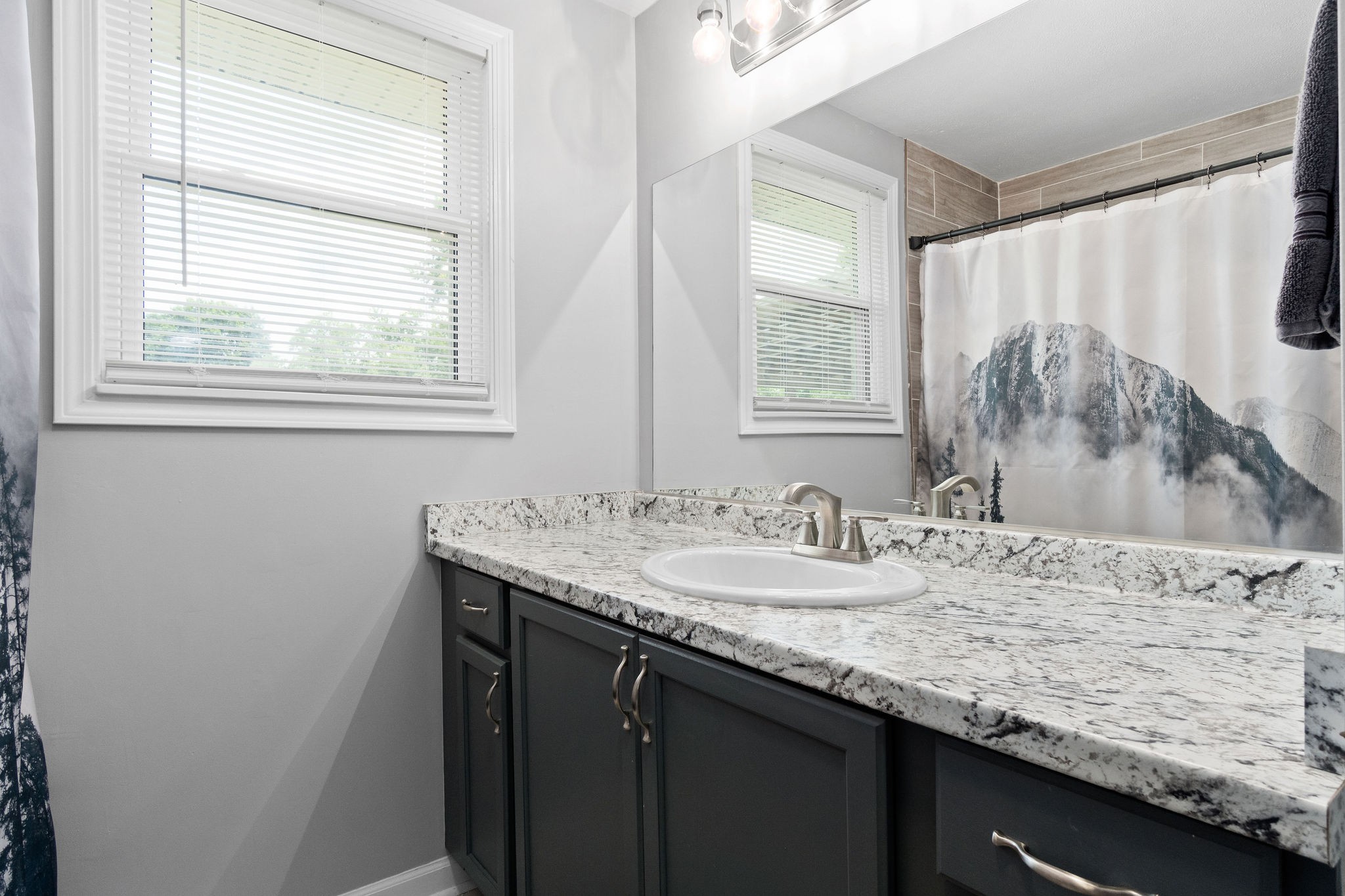 573 Lafayette Road Clarksville, TN 37042 - Photo 23 of 31 a bathroom with a granite countertop sink a window and a mirror