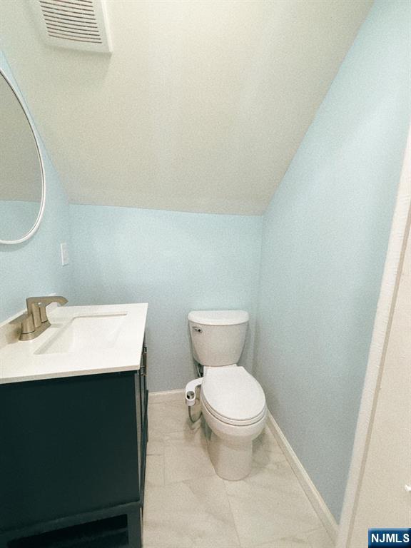 9-04 5th Street Fair Lawn, NJ 07410 - Photo 16 of 17 a bathroom with a sink a toilet and a mirror