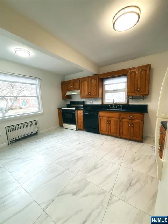 9-04 5th Street Fair Lawn, NJ 07410 - Photo 4 of 17 a large kitchen with stainless steel appliances granite countertop a stove sink and window