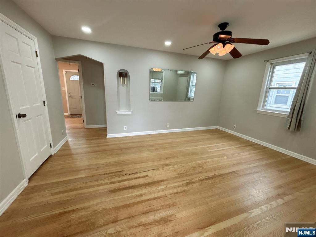 9-04 5th Street Fair Lawn, NJ 07410 - Photo 5 of 17 an empty room with wooden floor and windows