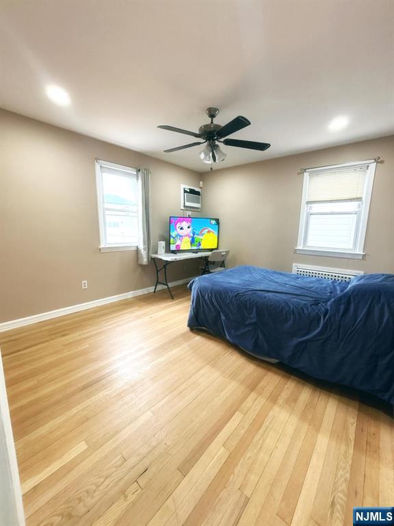 9-04 5th Street Fair Lawn, NJ 07410 - Photo 6 of 17 a bedroom with a bed and a chandelier