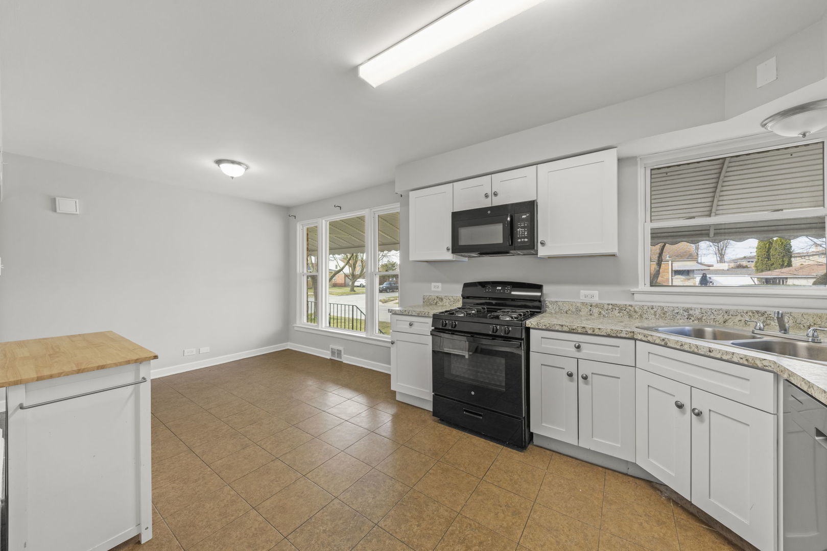 2301 18th Avenue North Riverside, IL 60546 - Photo 11 of 28 a kitchen with granite countertop white cabinets and stainless steel appliances