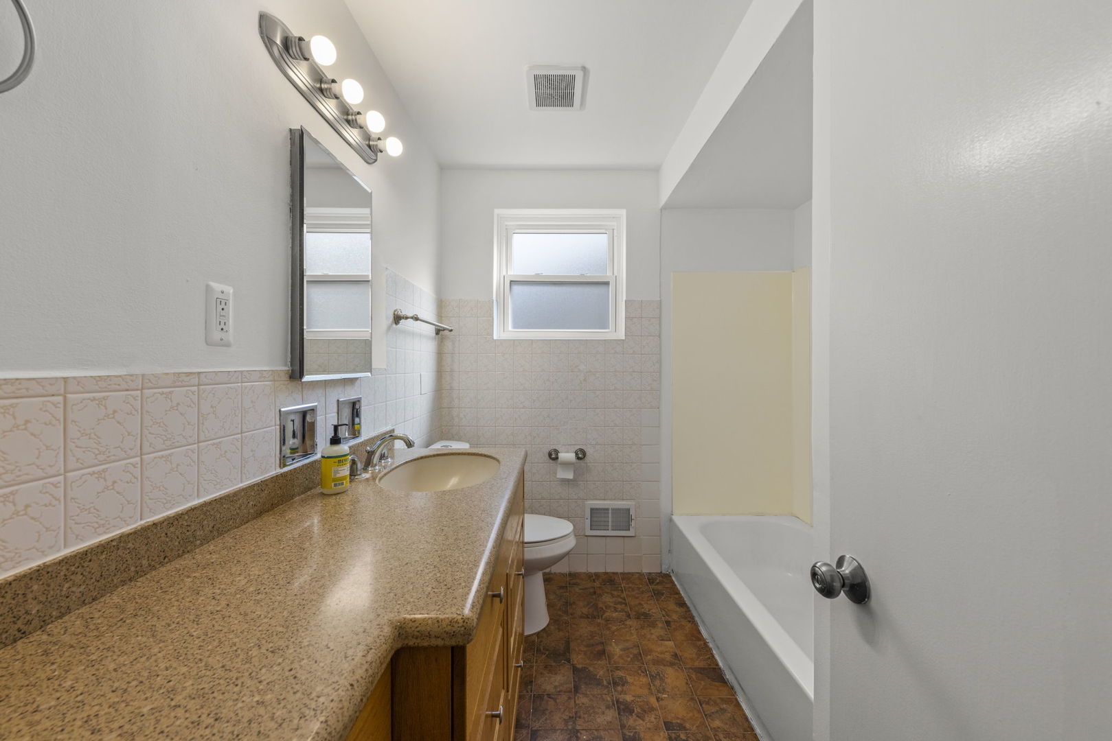 2301 18th Avenue North Riverside, IL 60546 - Photo 15 of 28 a bathroom with a tub sink and mirror