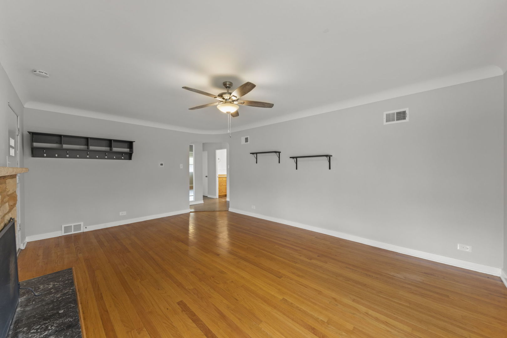 2301 18th Avenue North Riverside, IL 60546 - Photo 7 of 28 a view of an empty room with wooden floor and a ceiling fan