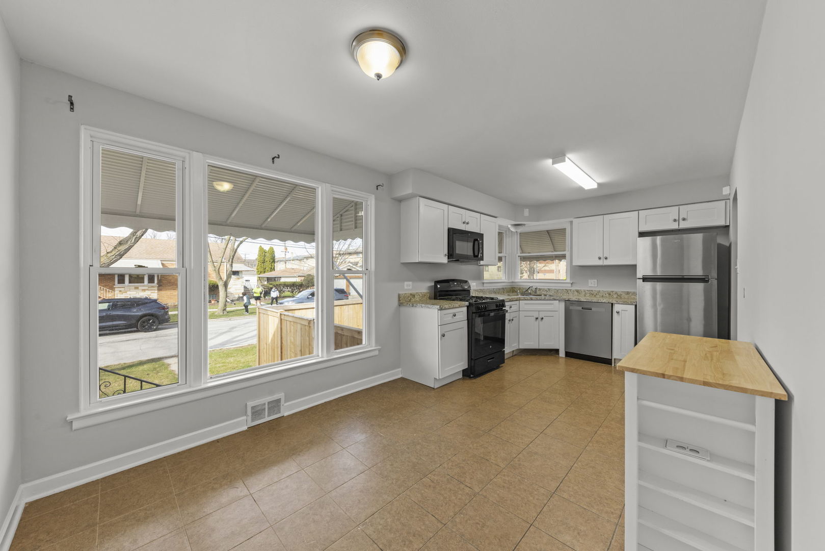 2301 18th Avenue North Riverside, IL 60546 - Photo 8 of 28 a kitchen with stainless steel appliances a refrigerator a sink a stove top oven and white cabinets