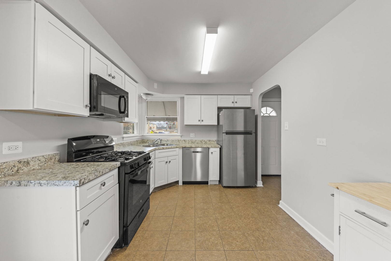 2301 18th Avenue North Riverside, IL 60546 - Photo 10 of 28 a kitchen with refrigerator a microwave a sink and cabinets