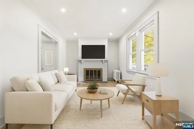 a living room with furniture a fireplace and a flat screen tv