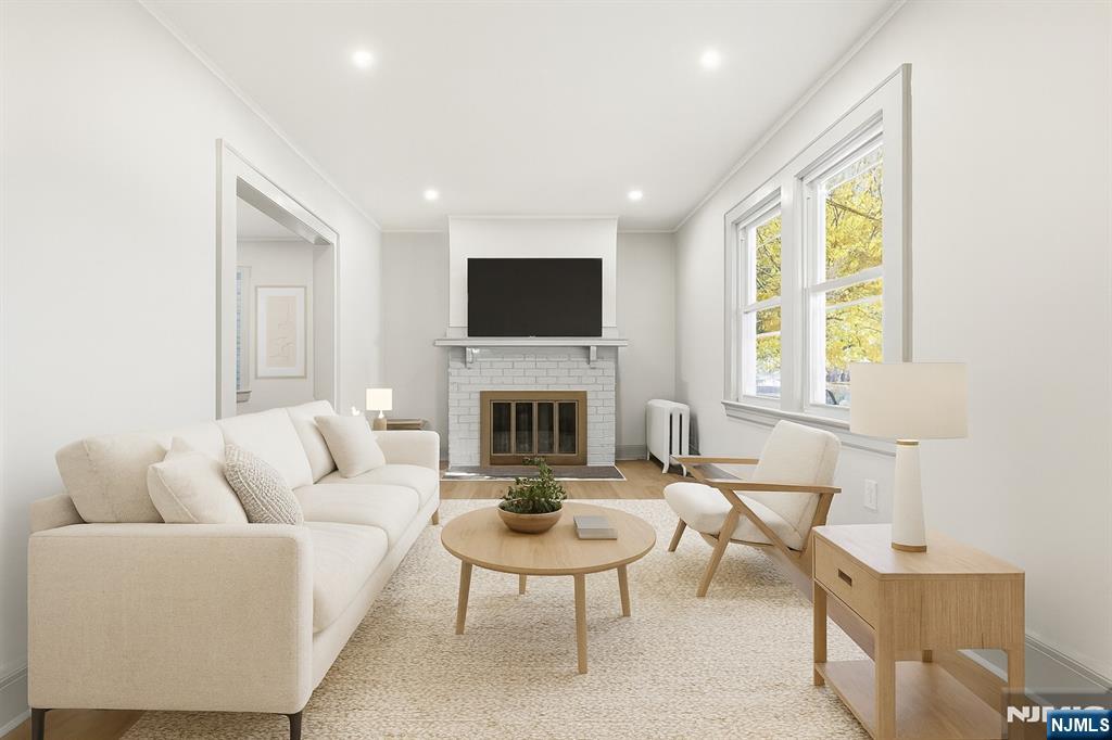 28 State Street, Unit 1 Bloomfield, NJ 07003 - Photo 2 of 8 a living room with furniture a fireplace and a flat screen tv