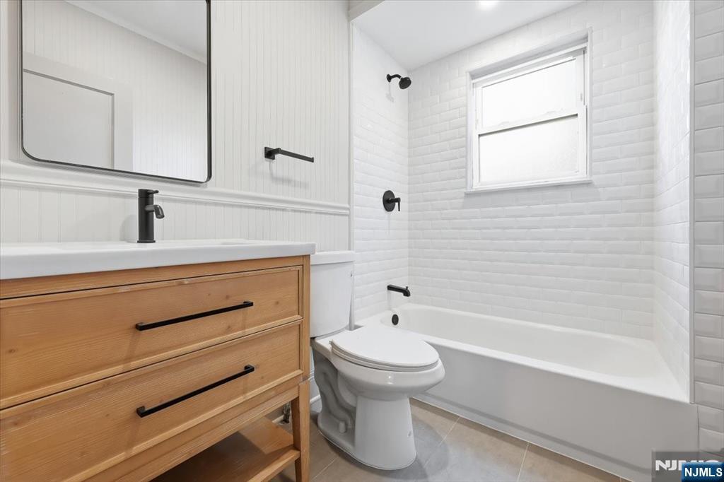 28 State Street, Unit 1 Bloomfield, NJ 07003 - Photo 3 of 8 a bathroom with a sink a toilet and bathtub