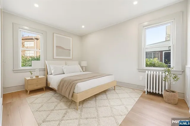 a spacious bedroom with a bed and a window