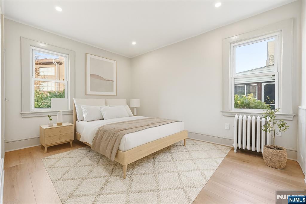 28 State Street, Unit 1 Bloomfield, NJ 07003 - Photo 5 of 8 a spacious bedroom with a bed and a window