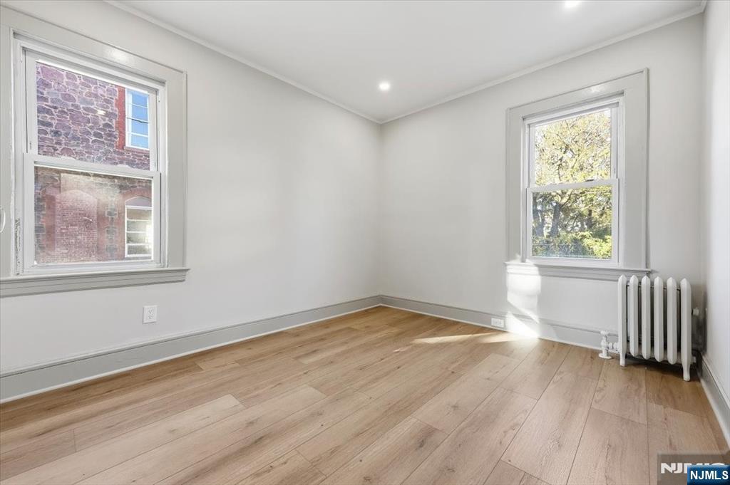 28 State Street, Unit 1 Bloomfield, NJ 07003 - Photo 6 of 8 a view of an empty room with wooden floor and a window