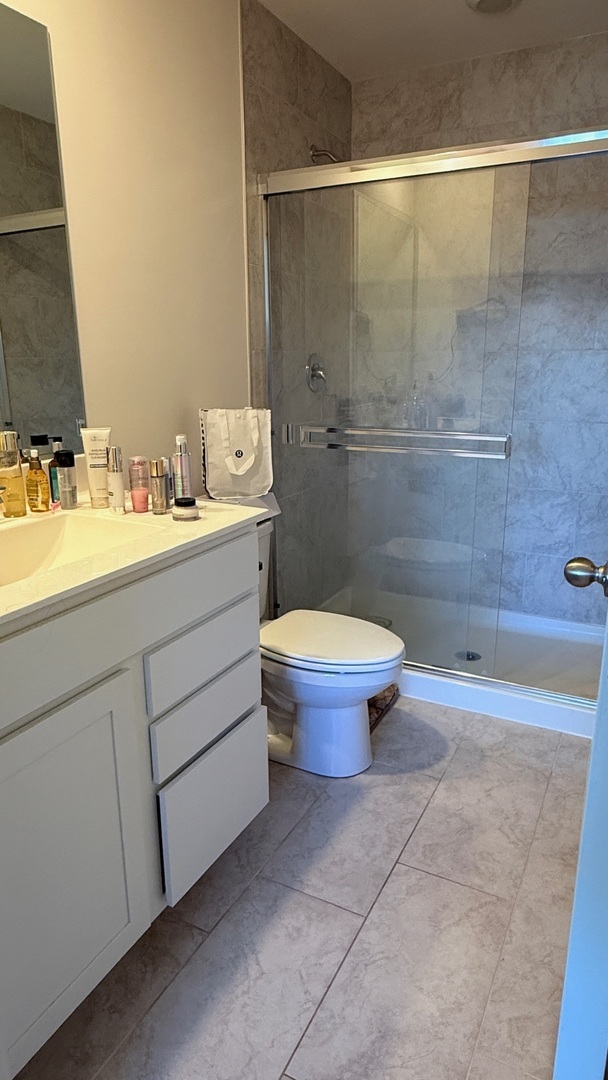 2008 Yellowstone Boulevard, Unit 2008 Mundelein, IL 60060 - Photo 13 of 25 a bathroom with a granite countertop sink toilet and shower