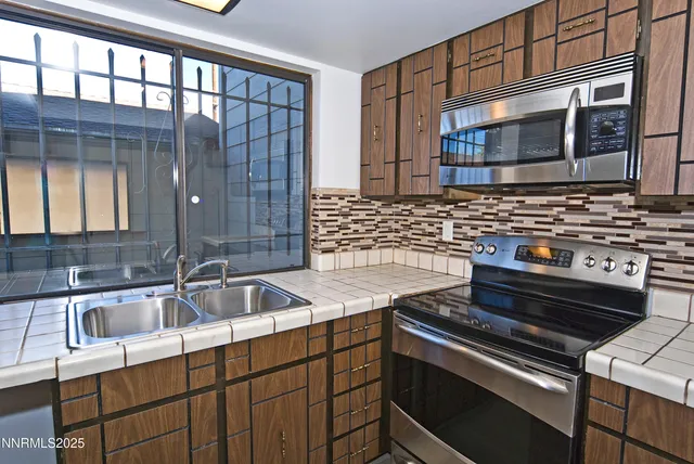 a kitchen that has a sink and a stove