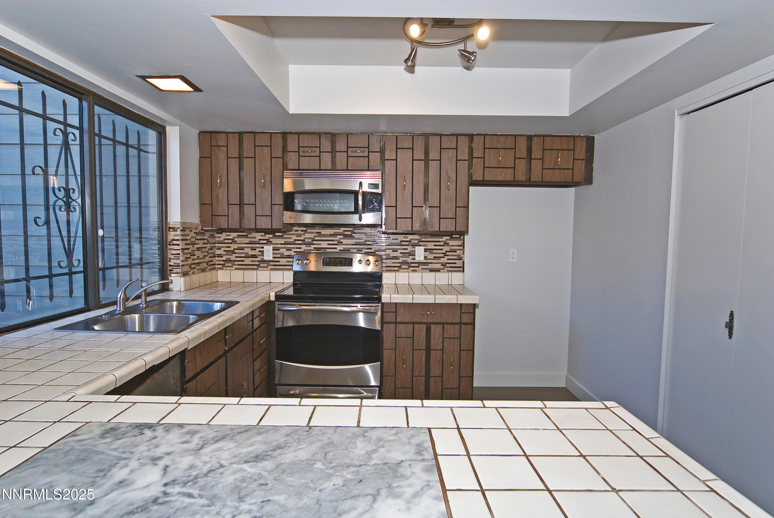 1433 Foster Drive Reno, NV 89509 - Photo 13 of 23 a kitchen with a sink a stove and cabinets