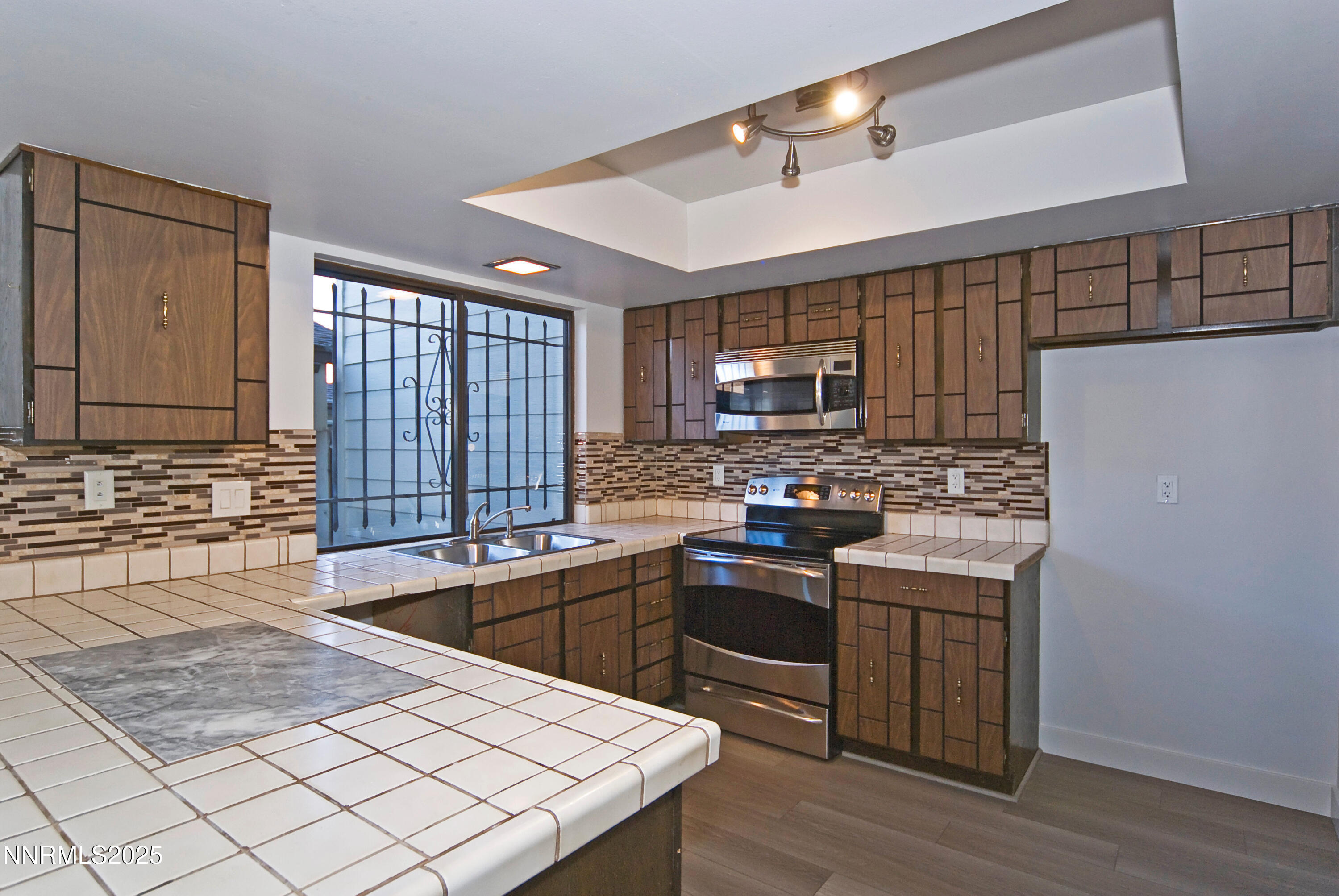 1433 Foster Drive Reno, NV 89509 - Photo 14 of 23 a kitchen with stainless steel appliances granite countertop a sink stove and refrigerator